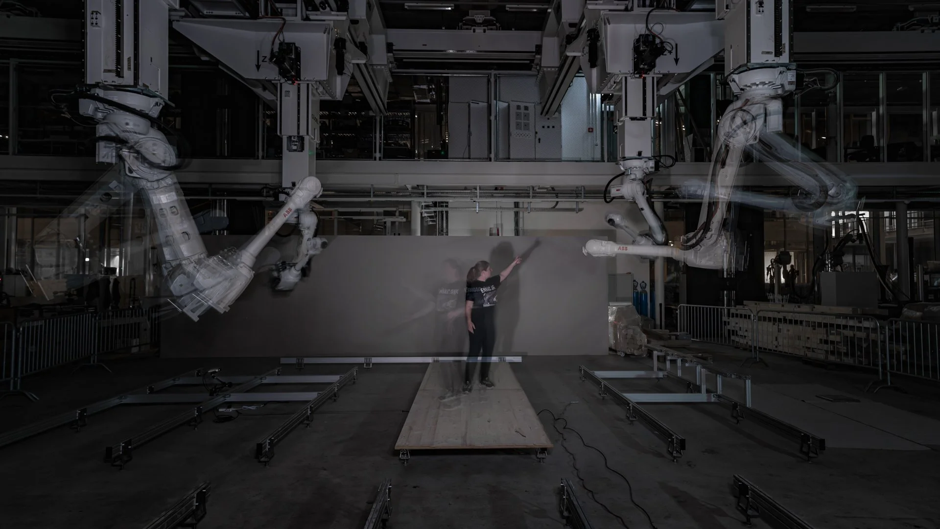 Madeline Gannon interacting through gesture and proximity with non-humanoid industrial robot arms in Other Natures